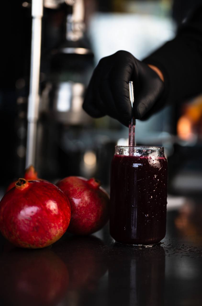 Pomegranate juice in a chilled glass with fresh fruit