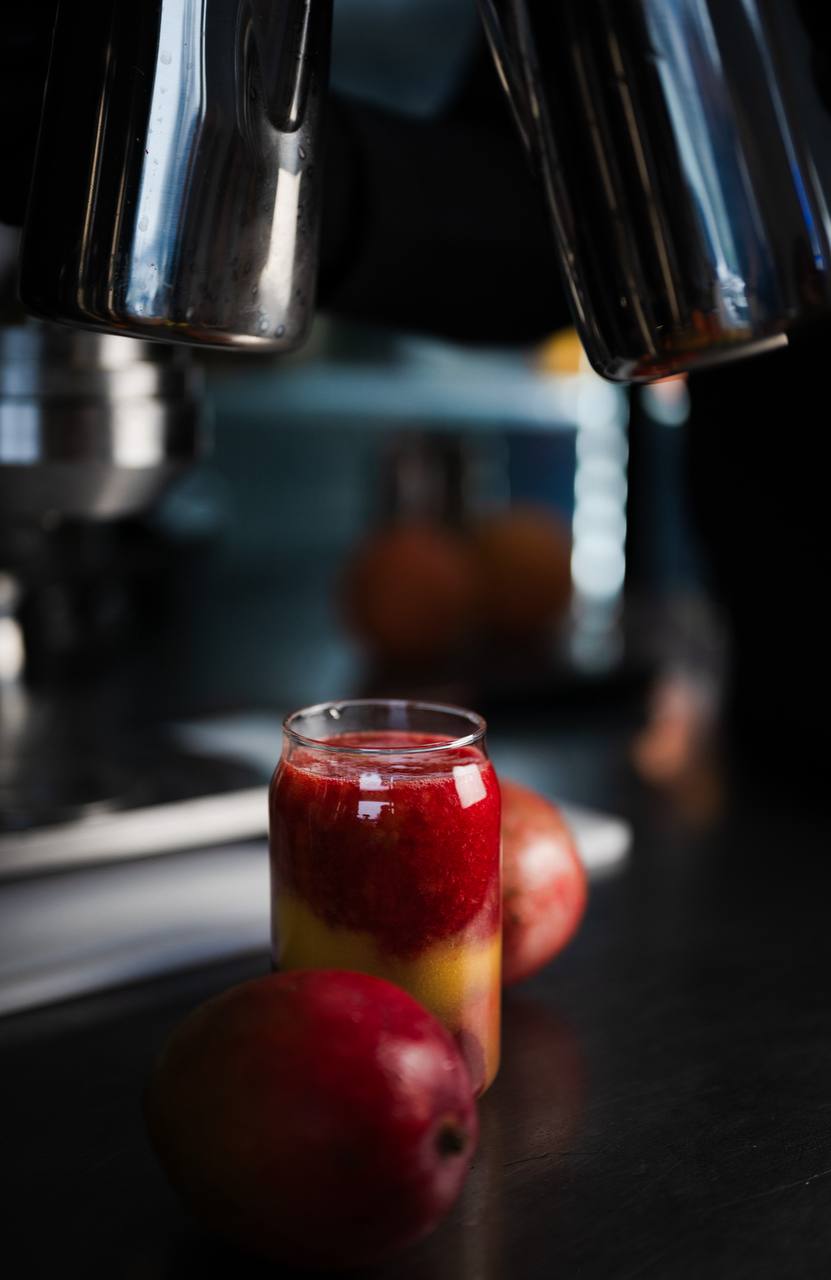 Layered tropical juice with fresh mango